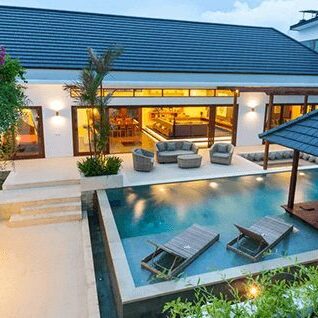 Home Exterior design showing tropical pool villa with sun bed